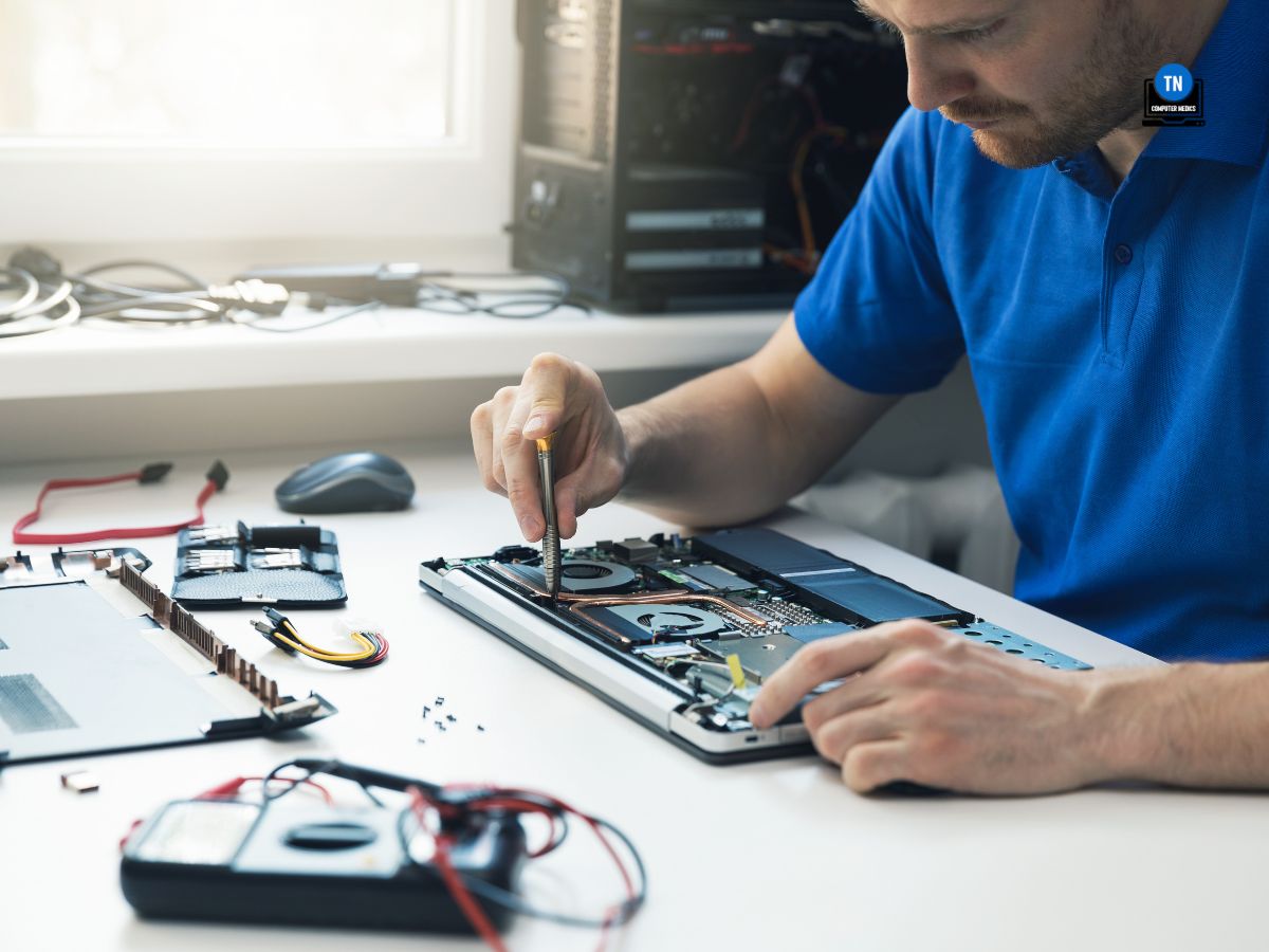 computer repair service - technician repairing broken laptop in office - Computer Repair Murfreesboro